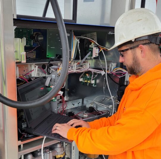 Working on Wiring Man working on equipment for fuel service